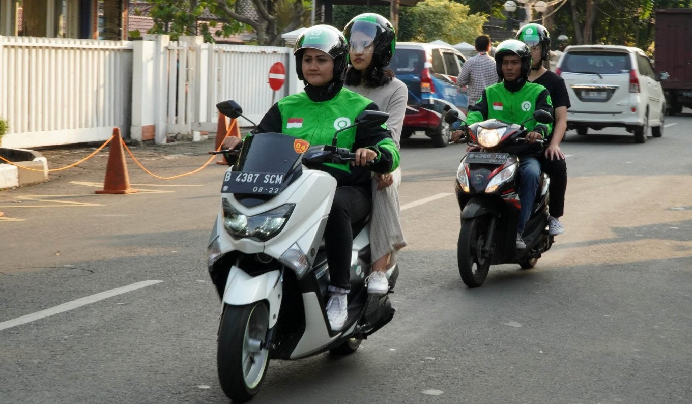 Riders on the road in city traffic